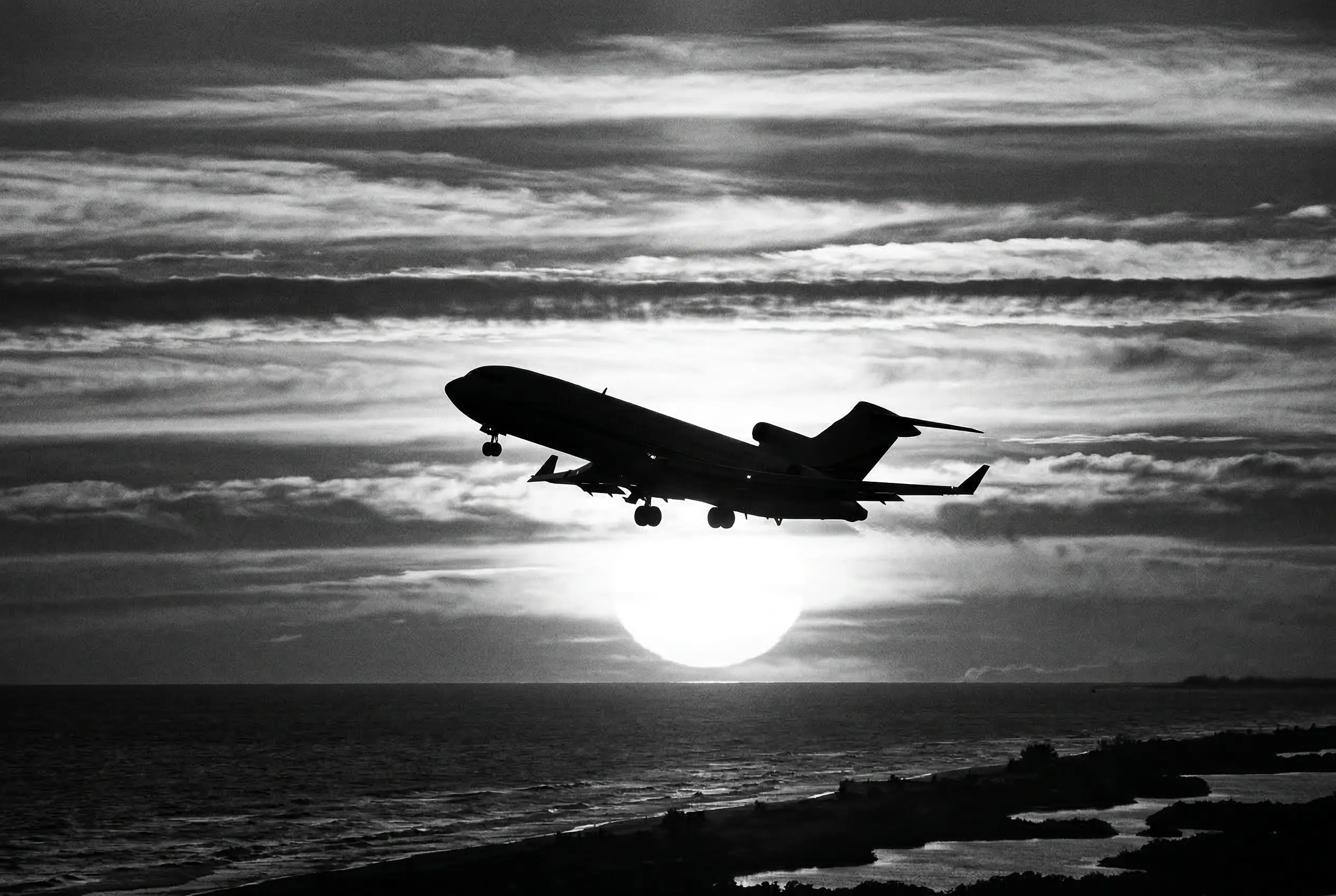 Private jet silhouetted against dramatic clouds after takeoff